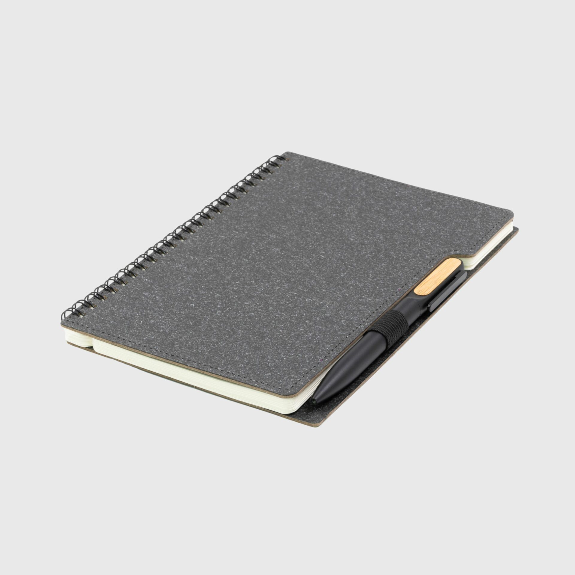 A5 Sustainable Eco Spiral Hardcover Notebook Made From Recycled Paper paired with bamboo pen